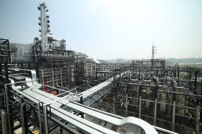 Petrochemical processing facility with pipework and towers